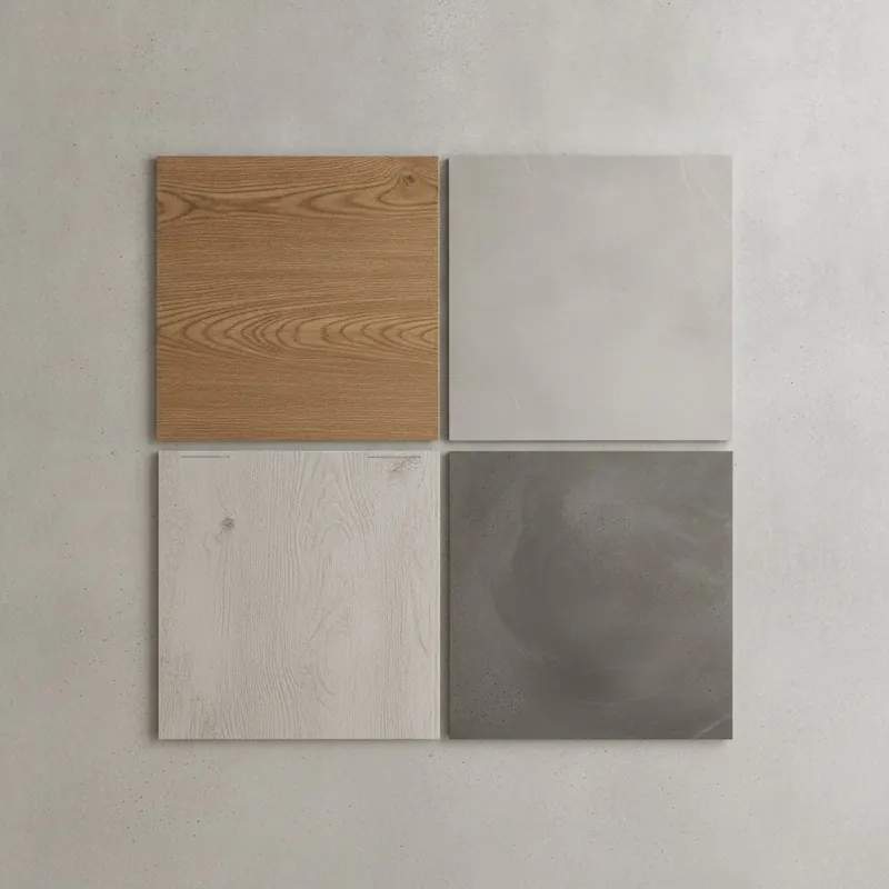 A top-down view of four durable flooring samples: luxury vinyl plank, porcelain tile, laminate, and sealed concrete.